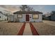 Charming one-story home featuring a red front door and low maintenance landscaping at 766 Fulton Ave, Brighton, CO 80601