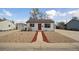 Charming single-story home with a bright red door and low maintenance rock landscaping at 766 Fulton Ave, Brighton, CO 80601