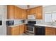Well-equipped kitchen with updated appliances, stylish backsplash, and ample cabinet space for storage and organization at 766 Fulton Ave, Brighton, CO 80601