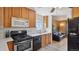 Modern kitchen featuring stainless steel appliances, sleek countertops, and an open view to the inviting living room at 766 Fulton Ave, Brighton, CO 80601