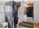Modern laundry area with stacked washer/dryer combo and kitchen view at 766 Fulton Ave, Brighton, CO 80601