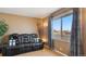 Comfortable living room showcasing a plush sofa and a bright window with outside view at 766 Fulton Ave, Brighton, CO 80601