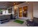 Charming covered back patio featuring a hot tub, sliding glass doors, and decorative string lights at 12292 W 65Th Ave, Arvada, CO 80004