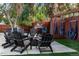 Inviting backyard retreat with Adirondack chairs, fire pit, hammock and plush artificial turf at 12292 W 65Th Ave, Arvada, CO 80004
