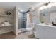 Neutral bathroom with a tiled shower, floating shelves, and white vanity at 12292 W 65Th Ave, Arvada, CO 80004