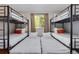 Bedroom with multiple bunkbeds, white linens, orange accents and natural lighting at 12292 W 65Th Ave, Arvada, CO 80004