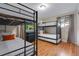 Bedroom featuring multiple bunk beds, hardwood floors, neutral walls and natural lighting at 12292 W 65Th Ave, Arvada, CO 80004