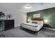 Spacious bedroom with neutral tones, carpet, and a king bed with decorative pillows at 12292 W 65Th Ave, Arvada, CO 80004