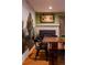 The dining area includes a fireplace, eye-catching wall art, and a spacious table, creating a cozy and inviting space at 12292 W 65Th Ave, Arvada, CO 80004