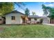 Charming, single-story home featuring a well-maintained lawn and a convenient ramp leading to the front door at 12292 W 65Th Ave, Arvada, CO 80004