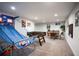 Finished basement featuring a foosball table, basketball game, and a seating area at 12292 W 65Th Ave, Arvada, CO 80004