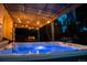 Relaxing outdoor space with a hot tub, covered patio, and inviting ambiance at 12292 W 65Th Ave, Arvada, CO 80004