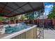 Backyard featuring a hot tub, covered patio, and outdoor seating for entertaining at 12292 W 65Th Ave, Arvada, CO 80004