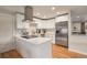 Bright kitchen with white cabinetry, stainless steel appliances, and hardwood floors, offering a clean and modern aesthetic at 12292 W 65Th Ave, Arvada, CO 80004