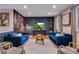 Cozy living room with plush blue sofas, a statement wall, and natural light creating a warm and inviting atmosphere at 12292 W 65Th Ave, Arvada, CO 80004