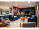 Stylish living room with a blue sofa, hardwood floors, and unique floral wallpaper at 12292 W 65Th Ave, Arvada, CO 80004