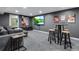 Finished basement with a large screen tv, pub table, and bar stools at 12292 W 65Th Ave, Arvada, CO 80004