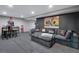Finished basement with a large sectional sofa, bar table, and movie decor at 12292 W 65Th Ave, Arvada, CO 80004