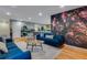 Spacious living room with an eye-catching floral mural, offering a unique and stylish aesthetic at 12292 W 65Th Ave, Arvada, CO 80004