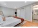 Cozy main bedroom with wood floors, a king bed, and an ensuite bathroom at 12292 W 65Th Ave, Arvada, CO 80004