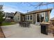 Backyard patio featuring a built in grill, outdoor dining, and beautiful landscaping at 549 Tippen Pl, Castle Rock, CO 80104