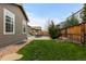 Backyard with green grass, concrete patio, built in grill and wooden fence at 549 Tippen Pl, Castle Rock, CO 80104