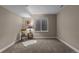 Finished basement with a sitting area, featuring carpet, a small window, and neutral paint at 549 Tippen Pl, Castle Rock, CO 80104
