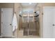 Luxurious bathroom featuring a tiled shower with glass enclosure and built-in seat at 549 Tippen Pl, Castle Rock, CO 80104