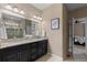 Bright bathroom featuring a double vanity, granite countertop, and a glass-enclosed shower at 549 Tippen Pl, Castle Rock, CO 80104