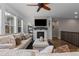 Inviting living room features plush sofa, fireplace, large windows and open access to an upper level at 549 Tippen Pl, Castle Rock, CO 80104