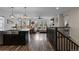 Open-concept living space with wood floors connecting the kitchen, living, and dining areas at 549 Tippen Pl, Castle Rock, CO 80104