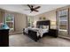 Serene main bedroom showcasing a large bed, soft lighting, and windows with peaceful outdoor views at 549 Tippen Pl, Castle Rock, CO 80104