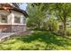 Lush backyard with mature trees, garden area, and privacy fence at 1919 Bellaire St, Denver, CO 80220