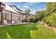 Spacious backyard with a pergola, patio, and lush lawn at 1919 Bellaire St, Denver, CO 80220