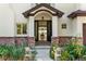 Inviting front entrance with charming brick accents and sculpted lion statues leading to the front door at 1919 Bellaire St, Denver, CO 80220