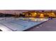 Stunning community pool at night with lounge chairs providing a relaxing and luxurious amenity for residents at 4663 Hatcher Dr, Brighton, CO 80601