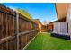 Backyard featuring a new privacy fence, artificial turf, storage shed, and patio area at 6495 E Happy Canyon Rd # 62, Denver, CO 80237