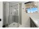 Updated bathroom featuring a glass enclosed shower with tile surround and a window for natural light at 6495 E Happy Canyon Rd # 62, Denver, CO 80237