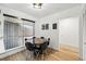 Cozy dining area with a modern table, hardwood floors, and natural light from the windows at 6495 E Happy Canyon Rd # 62, Denver, CO 80237