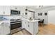 Bright kitchen with marble backsplash, stainless steel appliances, and breakfast bar, flowing into the dining area at 6495 E Happy Canyon Rd # 62, Denver, CO 80237
