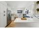 Bright kitchen features stainless steel appliances, white cabinetry, marble backsplash, and a large island at 6495 E Happy Canyon Rd # 62, Denver, CO 80237