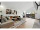 Open living room with a large sectional sofa, stylish artwork, and sliding glass doors at 6495 E Happy Canyon Rd # 62, Denver, CO 80237