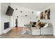 Bright living room features a vaulted ceiling, a fireplace with TV, and a large sectional sofa at 6495 E Happy Canyon Rd # 62, Denver, CO 80237