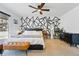 Bright main bedroom featuring modern accent wall, ceiling fan, large bed, and stylish furnishings at 6495 E Happy Canyon Rd # 62, Denver, CO 80237