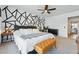 Bright main bedroom featuring modern accent wall, ceiling fan, large bed, and stylish furnishings at 6495 E Happy Canyon Rd # 62, Denver, CO 80237