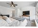 Bright main bedroom featuring modern furnishings, ceiling fan, and large window with neighborhood view at 6495 E Happy Canyon Rd # 62, Denver, CO 80237