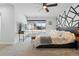 Bright main bedroom featuring modern accent wall, ceiling fan and large window with neighborhood view at 6495 E Happy Canyon Rd # 62, Denver, CO 80237