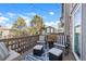 Well-furnished back deck with outdoor chairs and throw pillows, a patterned outdoor rug, and string lights at 13028 Grant W Cir # A, Thornton, CO 80241