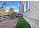 Backyard with a green stretch of artificial turf and a rock garden, and a back deck at 13028 Grant W Cir # A, Thornton, CO 80241