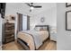 Cozy bedroom with gray upholstered bed, wood dresser, and neutral decor at 13028 Grant W Cir # A, Thornton, CO 80241